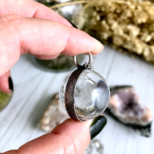 Large clear quartz crystal ball necklace by FOXLARK featuring a silver chain and a polished, transparent crystal pendant.