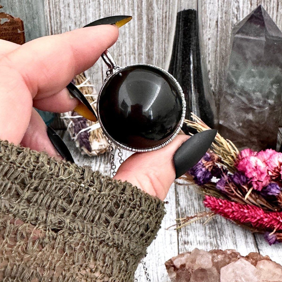 Black obsidian crystal ball necklace in silver from FOXLARK collection, featuring a sleek, polished stone pendant on a silver chain.