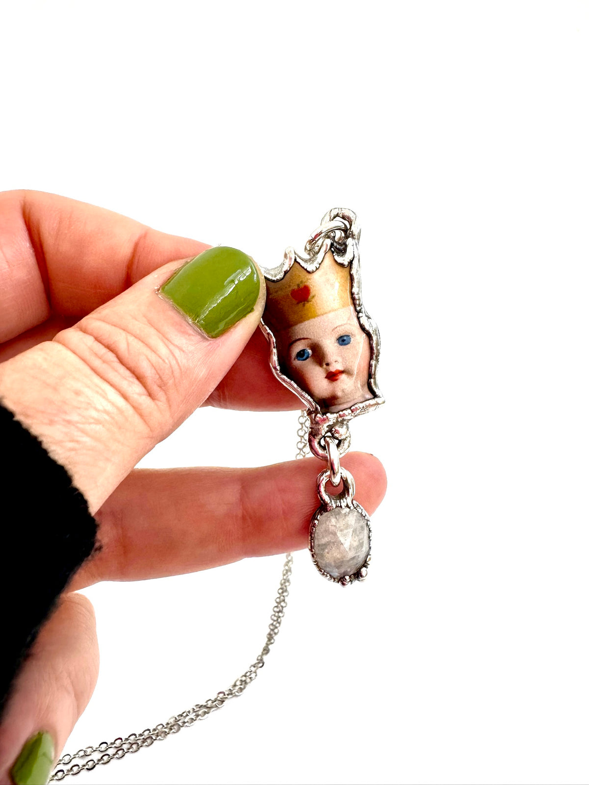 FoXLARK Weirdlings Collection doll head necklace featuring a rainbow moonstone charm in fine silver.