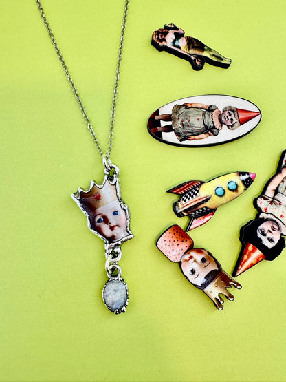 FOXLARK Weirdlings doll head necklace featuring rainbow moonstone charm and fine silver chain, detailed close-up.